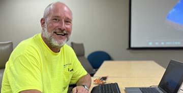 Walker J Walker employee working at a table with a computer